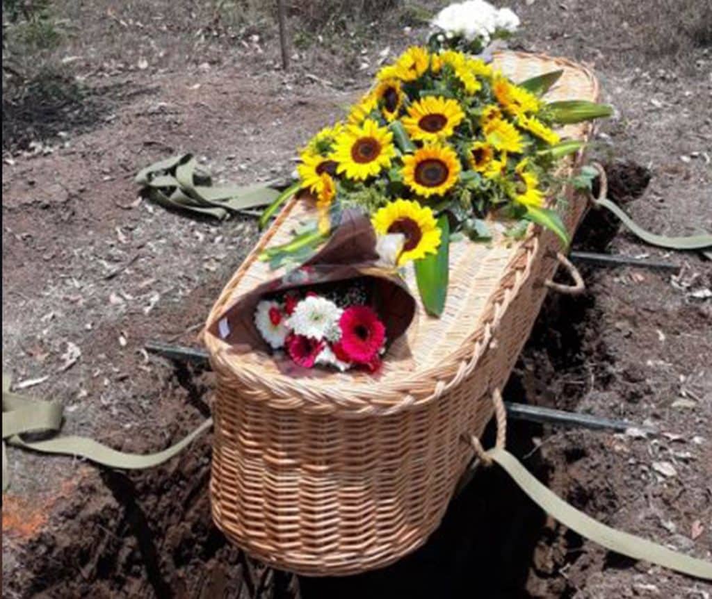 Woven Casket With Flowers — Newhaven Funerals in Brisbane