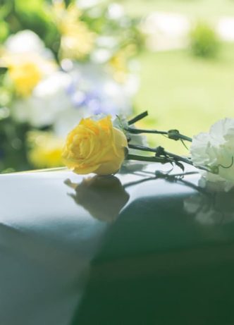 Flowers Atop A Funeral Casket — Newhaven Funerals in Brisbane