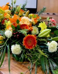 Colourful Flowers On Casket — Newhaven Funerals in Brisbane