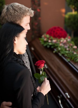 Couple In Black Holding Rose — Newhaven Funerals in Brisbane