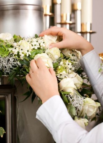 Mortician Preparing Funeral Flowers — Newhaven Funerals in Brisbane