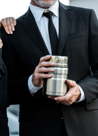 Man And Woman Holding Urn — Newhaven Funerals in Brisbane