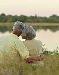 Older Couple Hugging Near Lake — Newhaven Funerals in Brisbane