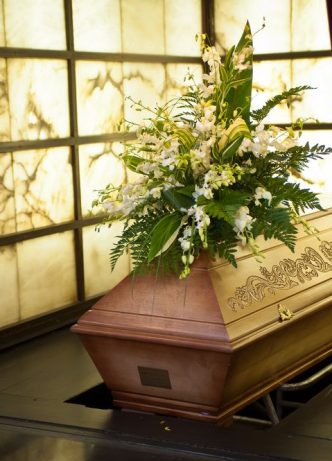 Wooden Coffin With Intricate Design — Newhaven Funerals in Brisbane