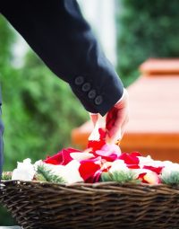 Woman Grabbing Flower Petals — Newhaven Funerals in Brisbane
