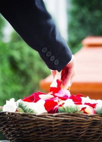 Woman Grabbing Flower Petals — Newhaven Funerals in Brisbane