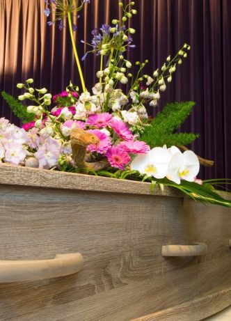 A Coffin With Flower Arrangement