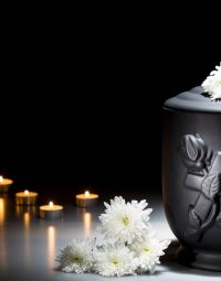 Red Ribbon On Black Urn — Newhaven Funerals in Brisbane