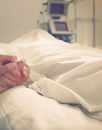 Woman Holding the hand of a Deceased partner