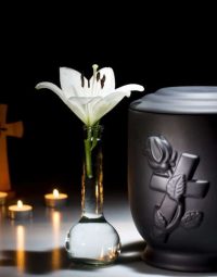 Black Urn With Lilly — Newhaven Funerals in Brisbane