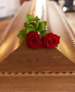 Red Rose Flower On Wooden Coffin — Newhaven Funerals in Brisbane
