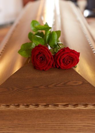 Red Rose Flower On Wooden Coffin — Newhaven Funerals in Brisbane