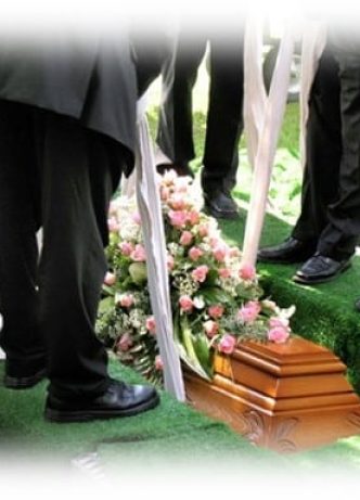 Men Lowering Casket Into The Ground — Newhaven Funerals in Brisbane