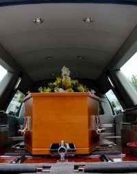 Wooden Coffin Inside Black Car — Newhaven Funerals in Brisbane