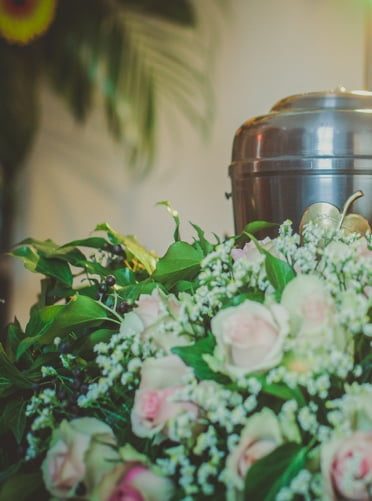 Urn Sitting In Flowers — Newhaven Funerals in Brisbane