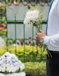 Man Holding Flowers — Newhaven Funerals in Brisbane