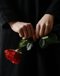Woman Holding Rose — Newhaven Funerals in Brisbane