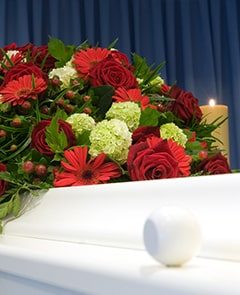 White Coffin with Flower — Newhaven Funerals in Brisbane