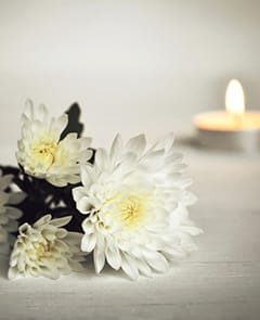 White Flower with Candle — Newhaven Funerals in Brisbane
